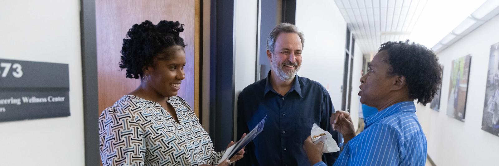 April Porter, Mike Johnson and Johné Parker talking outside of office